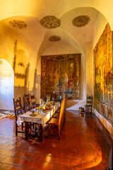 Medieval dining room with tapestries and long wooden table in Svihov Castle, Czechia