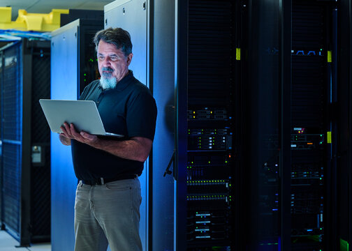 Man using laptop in data center