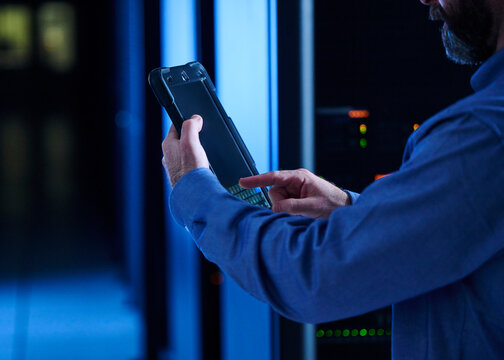 Close-up of man using tablet in data center