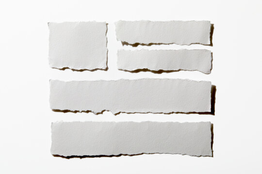 Pieces of torn paper on white background