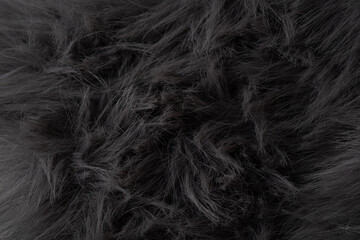 Fototapeta premium Close up view of luxurious dark shaggy faux fur fabric material providing a soft textured background