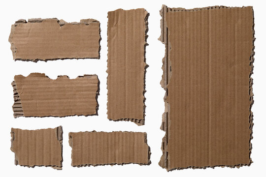 Pieces of torn cardboard on white background