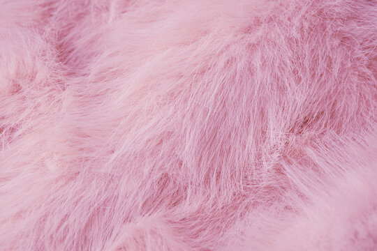 Soft light delicate pink fluffy wool like texture with gentle warm fuzzy fibers background