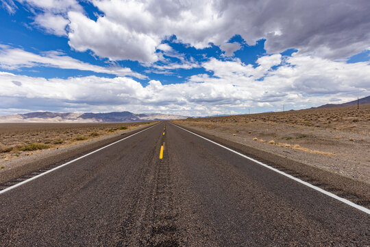 USA, Nevada, Henderson, Clouds over empty desert road