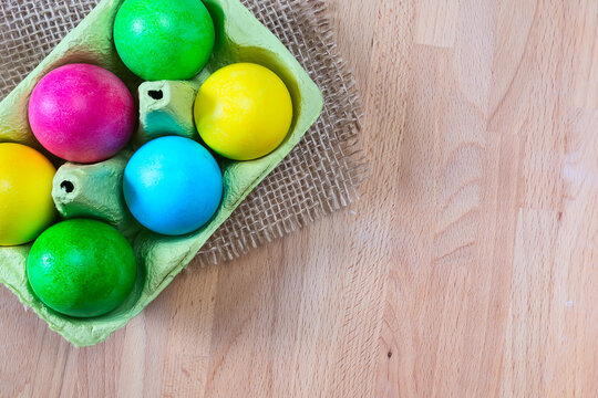 Colored Easter eggs in egg carton holder
