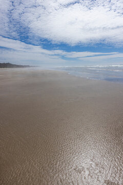 USA, Oregon, Newport, White puffy clouds above empty beach
