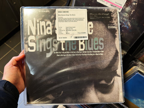 Classic blues vinyl album cover in protective plastic sleeve with bold typography.  Nina Simone Sings The Blues