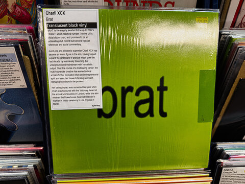 Charli XCX Brat vinyl cover in bright green packaging with translucent black vinyl detail