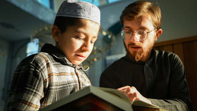 Muslim Sheikh reading Holy Quran to young students in a mosque. Ramadan spiritual atmosphere at masjid. Quranic lessons for children listening to mentor.