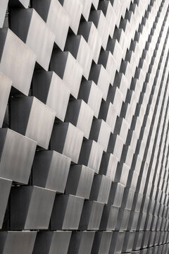 Modern abstract architecture facade with metal pattern texture and geometry in Stockholm Sweden featuring repeating panels and sharp perspective