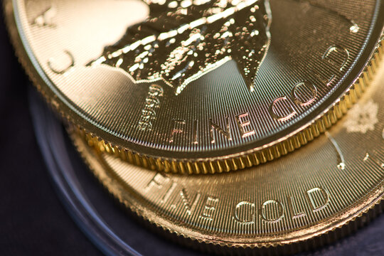 Two gold coins lying on top of each other, illustrating the concept of rising gold prices, futures contracts or gold funds, and gold as a safe-haven financial asset.