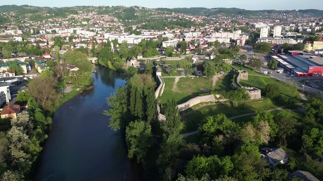 Waters of the river Vrbas go past the city of Banja Luka, Bosnia and Herzegovina. Aerial drone video, flying forwards.