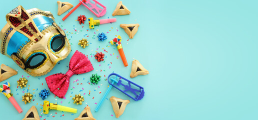 Purim celebration concept (jewish carnival holiday) over blue background