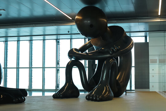 DOHA, QATAR - OCTOBER 25 2025: Large Modern Art Sculpture Of Sitting Figure At Hamad International Airport Doha