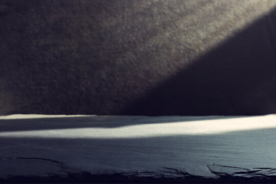 image of a black table and dark textured background.