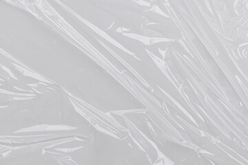 Obraz premium Clear scrunched plastic wrap, perfect for packaging and food preservation concepts. Ideal for designs related to sustainability and ecofriendly practices.