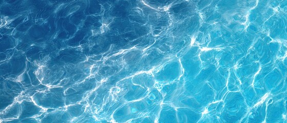 Obraz premium Close-up abstract shot of rippling water reflecting sunlight, showcasing blues and highlights