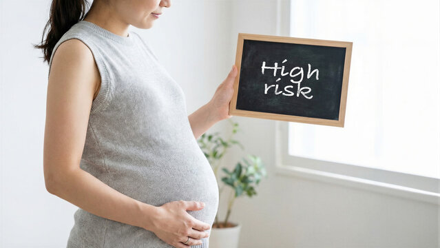 Pregnant woman holding chalkboard with high risk text, maternity health awareness, expecting mother with potential complications in bright room, healthcare pregnancy concept