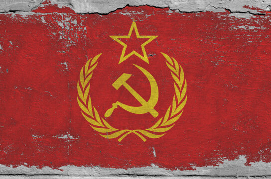 flag of the Soviet Union are painted on an old stone wall