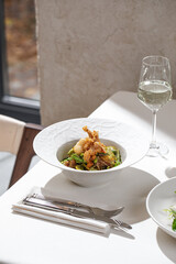Restaurant style salad with crispy fried shrimp mixed greens and light dressing served with white wine