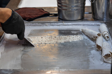 A person is making ice cream on a counter