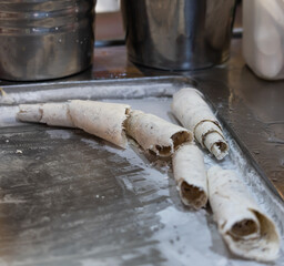 A tray of doughnuts with a few of them broken