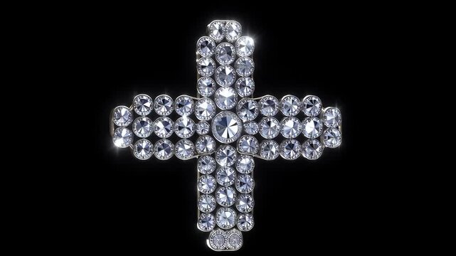 The image features a decorative cross made of shiny gemstones. The sparkling cross is prominent against a black background, emphasizing its details and design.