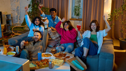 American football fans celebrating touchdown at home. Concept of victory emotion, fan culture, home viewing experience, sports entertainment, shared adrenaline and celebration moments. © master1305