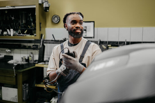 Young man repairing motocross bike in repair shop