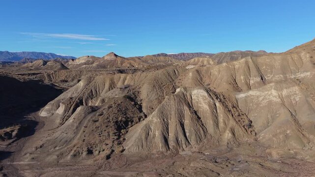 Drone footage capturing the arid landscape and eroded formations of the Tabernas Desert in Almeria