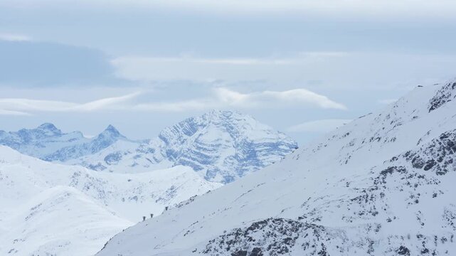 Alpinists hiking across snowy mountain ridge landscape in klosters davos