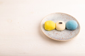 Japanese Mochi Cakes on white wooden, side view, copy space