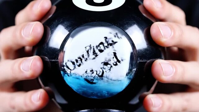 A person holds a black magic 8 ball with a blue dice inside