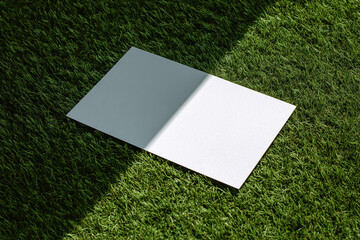 White Blank Card on Green Artificial Grass