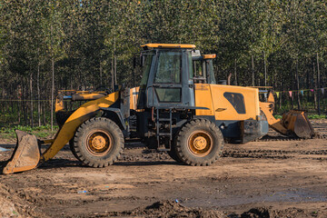 The bulldozer parked on the construction site is in operation