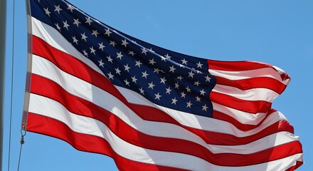 Obraz premium A Symbol of Freedom The American Flag Waving Proudly Under a Clear Blue Sky During Daytime