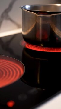 Pot electric stove glowing hotplate close up
