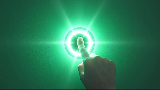 A hand pressing a glowing green button on a wall.