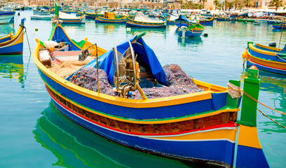 Obraz premium Colorful Fishing Boats Against Dock Background