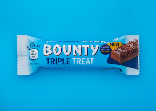 LONDON, UK - JANUARY 20, 2025: Bounty triple treat cereal chocolate bar on blue background.