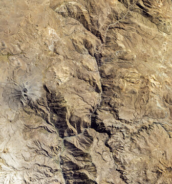 Satellite View Of Ubinas Volcano In Peru With Ash Covered Crater And Arid Landscape. Elements of this image furnished by NASA.