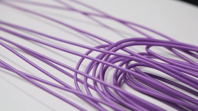 Purple Wires on White Background Closeup.