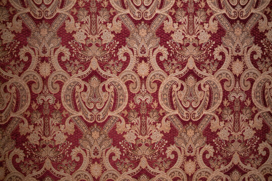 A richly detailed damask-style wallpaper photographed inside one of the historic chambers of the Royal Castle in Warsaw.