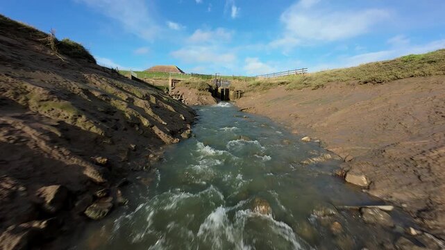 Fast FPV Drone View Over Foss Dyke River Drain in UK, Cinematic Low Altitude Flight Near Bridge Piers and Pumping Station Sluice Gates 4K