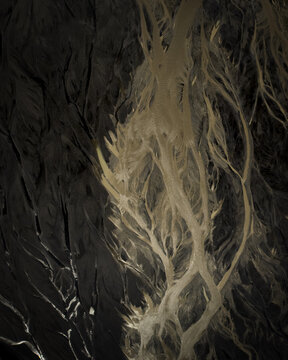 Aerial view of intricate patterns etched into the earth, revealing a network of pale lines against a dark canvas, Selfoss, Iceland.