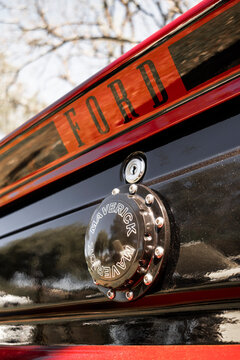 Close-up of the rear section of the classic Ford vehicle, highlighting the glossy black tailgate, chrome Maverick emblem, red stripe with Ford lettering.