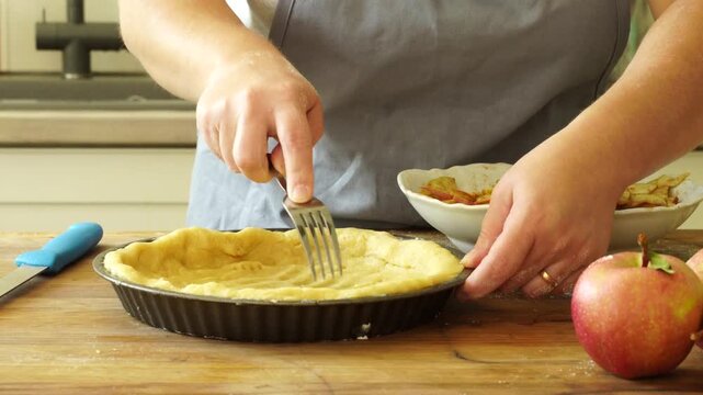 Woman makes an apple pie
