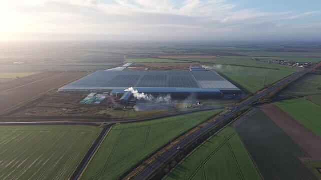 Aerial shot of a sustainable glass data centre in the English countryside representing the future of digital farming and technology in Europe.