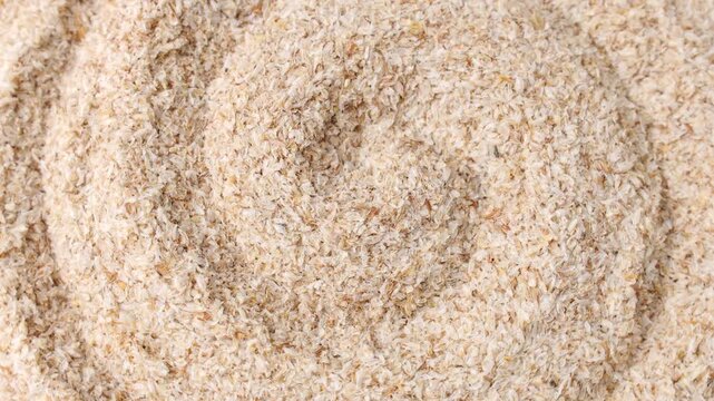 Psyllium husk (Ispaghula) texture circle rotation close up. Dietary fiber product