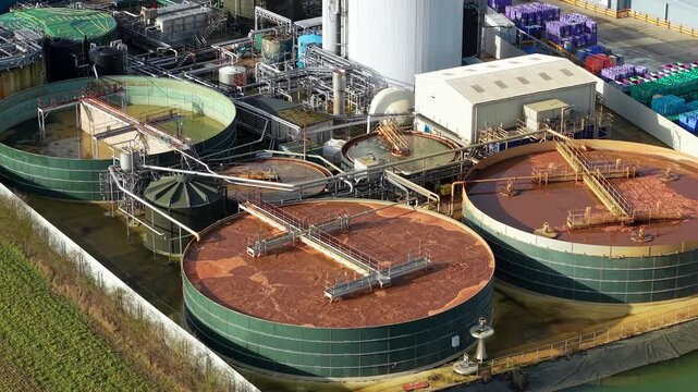 Close Up Aerial View of Industrial Treatment Tank with Bubbling Brown Liquid during Chemical Process